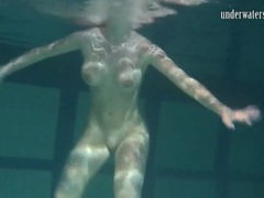 KiloLesbians presents: Naked brunette with big tits swims solo