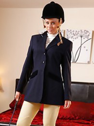 KiloLesbians presents: Clare R seductifvely removes her riding gear leaving on only opaque hold ups and sheer underwear